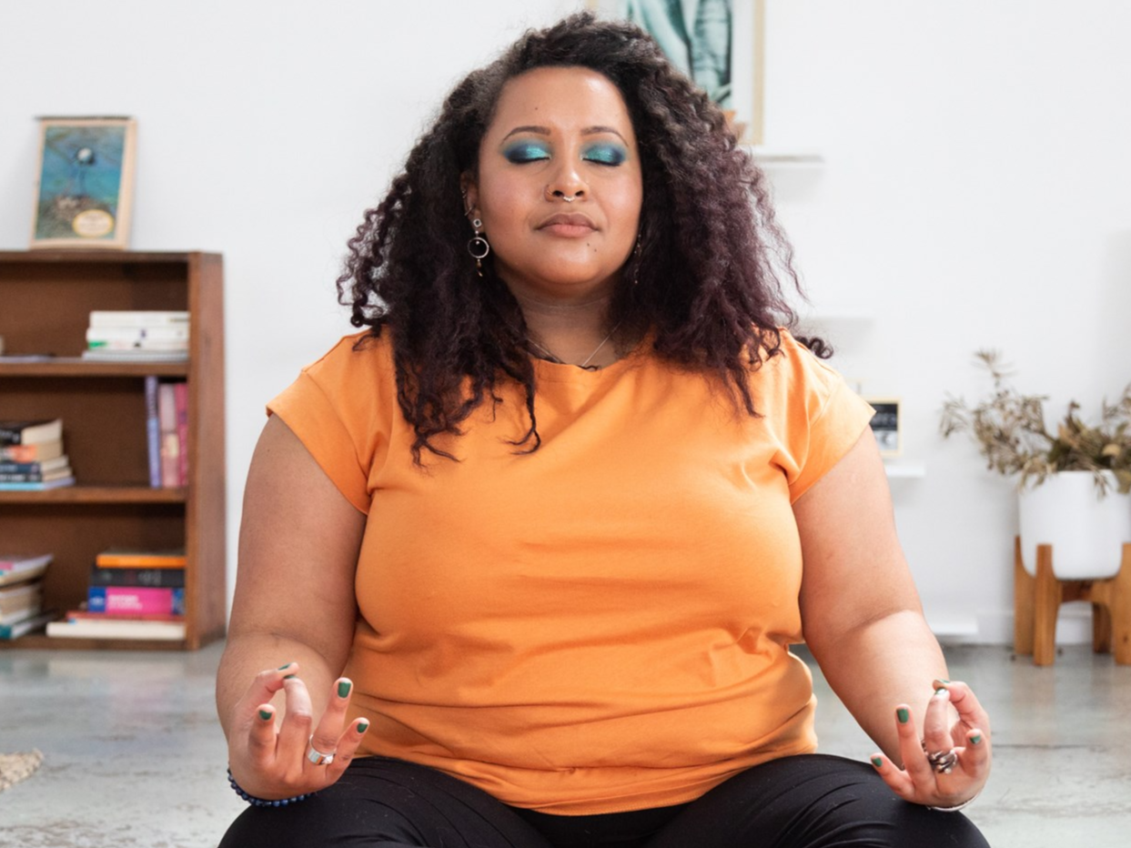 Woman with eyes closed holding a yoga pose.